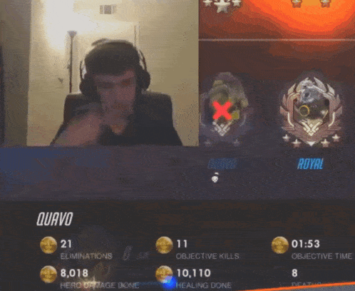 a man wearing headphones is playing a video game with the name quavo on the screen