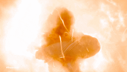 a man is surrounded by flames with the hashtag #superman on the bottom right