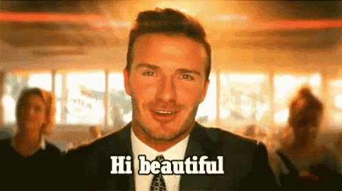 a man in a suit and tie is saying hi beautiful .