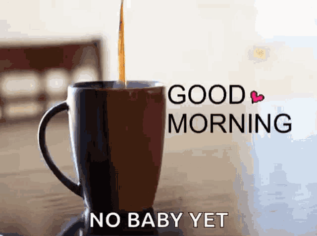 a cup of coffee with the words `` good morning no baby yet '' written on it .