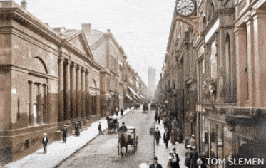 a black and white photo of a city street taken by tom sleman