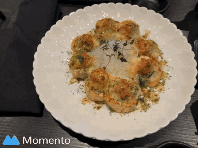 a plate of food with a momento logo on the bottom