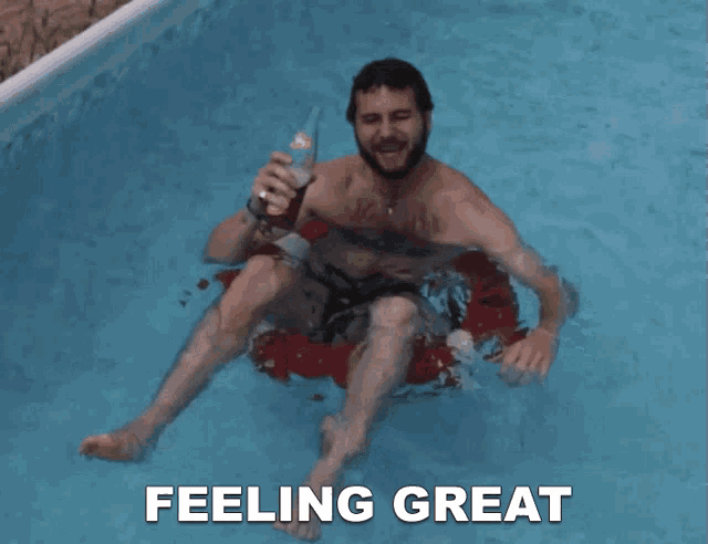 a man is floating in a swimming pool with the words feeling great above him