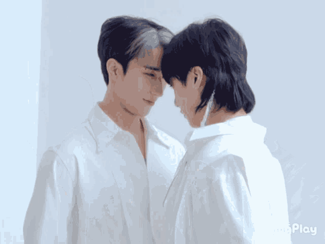 two men in white shirts are touching their foreheads and the word imgplay is on the bottom