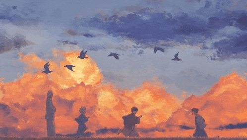 a group of people standing in a field at sunset with birds flying in the sky .