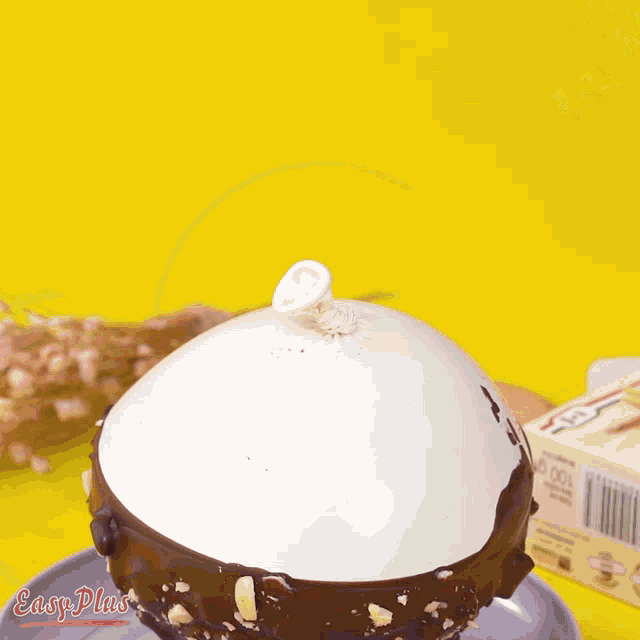 a person 's hand is reaching for a candle on a chocolate cake