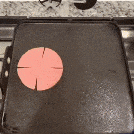 a black tray with two red circles cut in half