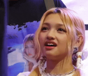 a close up of a woman 's face with a picture of a woman in the background