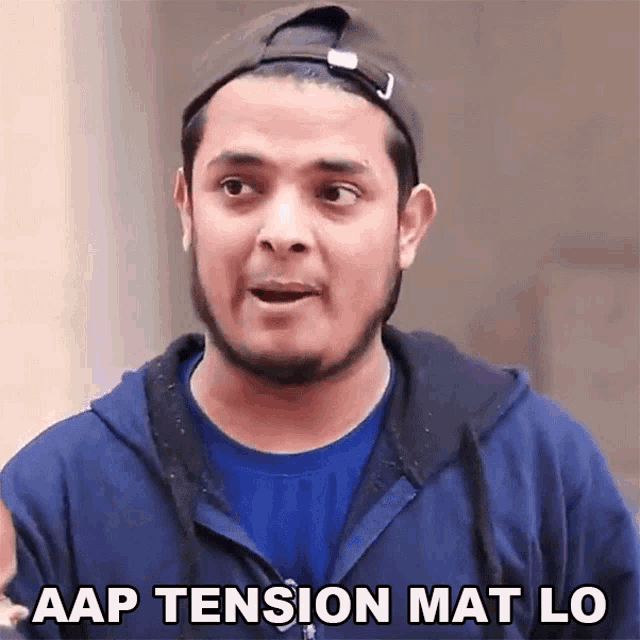 a man wearing a baseball cap and a blue shirt is making a funny face and says aap tension mat lo