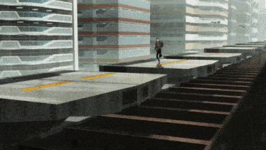 a man in a suit walks across a concrete platform in a city