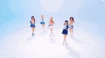 a group of girls are dancing together in front of a blue background