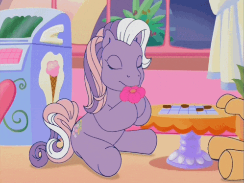 a cartoon pony is sitting on the floor with a flower in her mouth