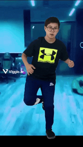 a young boy wearing a black under armour shirt