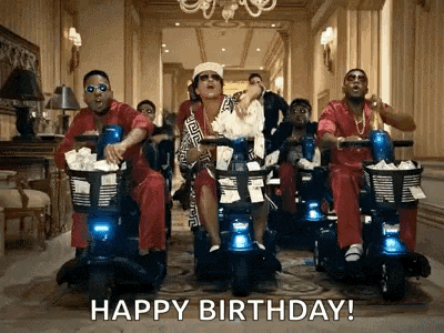 a group of men are riding scooters in a hallway with the caption happy birthday .