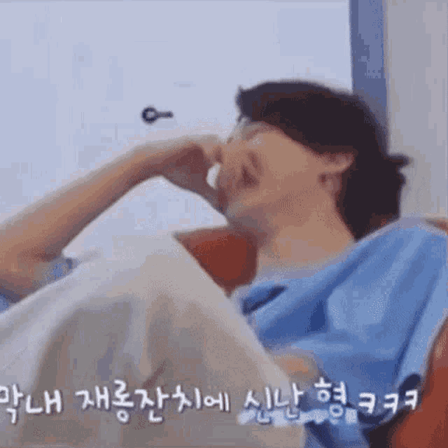 a man is laying in a hospital bed with a bandage on his nose and mouth .