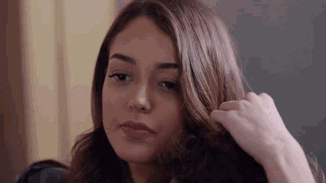 a close up of a woman 's face and hair