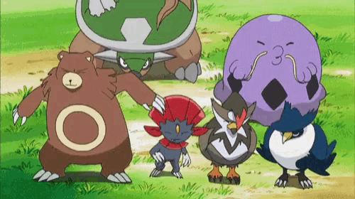 a group of pokemon standing next to each other on a grassy field .