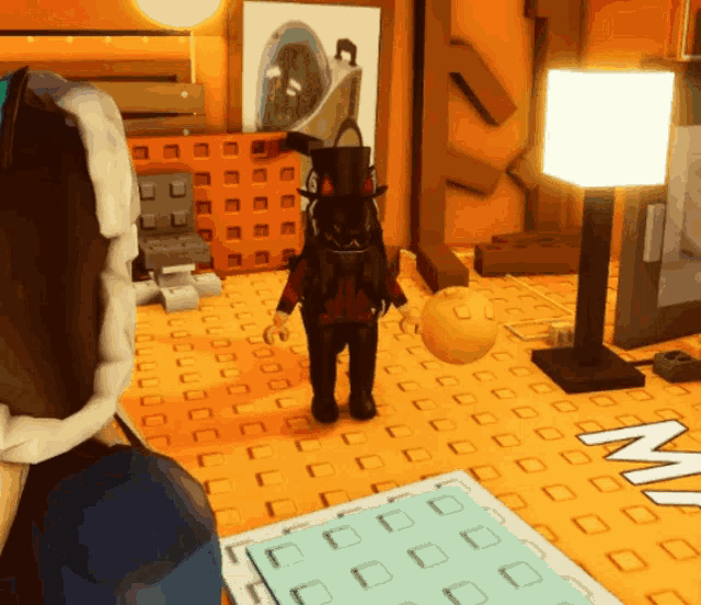 a person in a top hat is holding a yellow ball in a room with the letter m on the floor