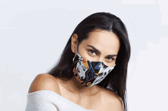 a woman wearing a colorful face mask with the word pop art on it