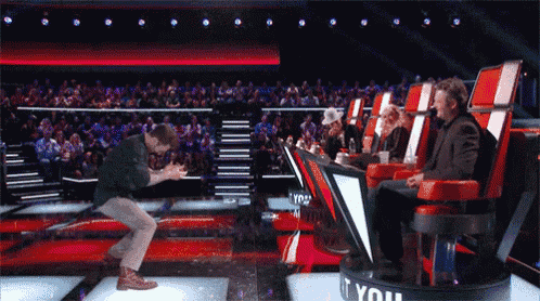 a man is dancing on a stage in front of a sign that says if you