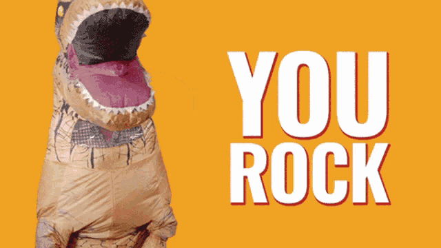 a t-rex in an inflatable costume with the words you rock behind it