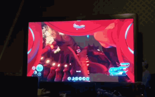 a computer monitor displays a video game with a red background