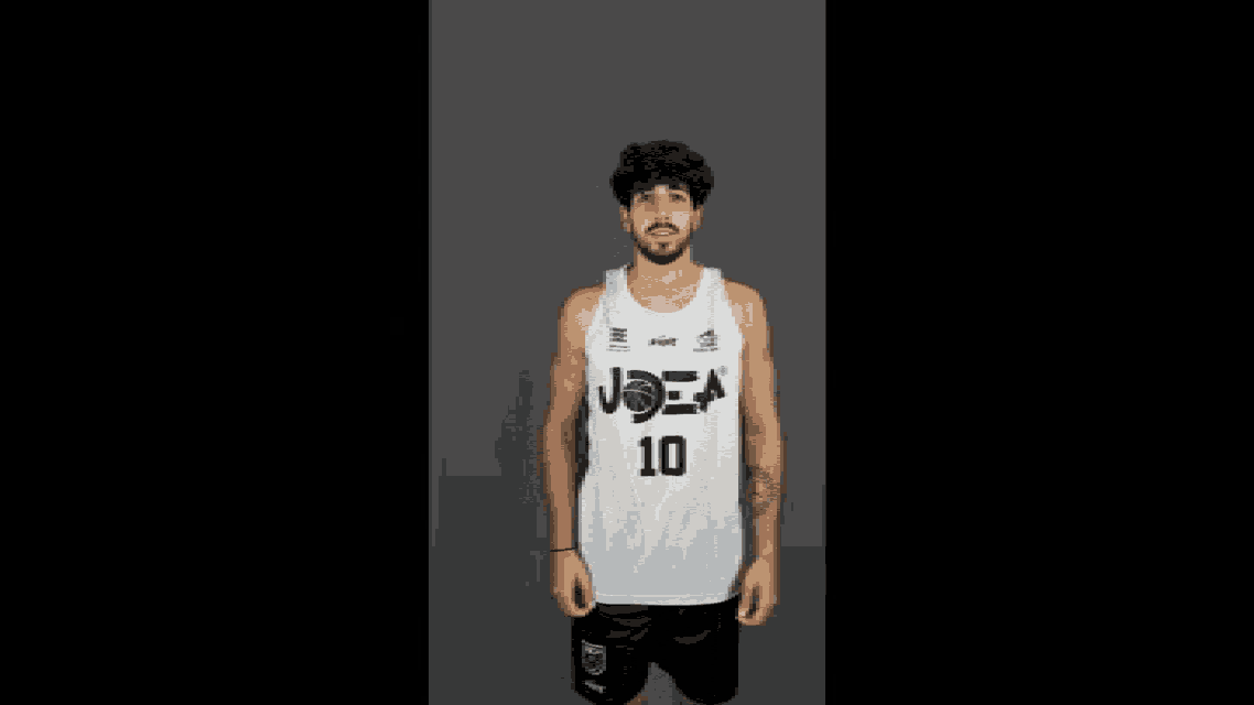 a man wearing a white tank top with the number 10 on the front