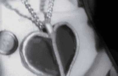 a black and white photo of a heart shaped necklace