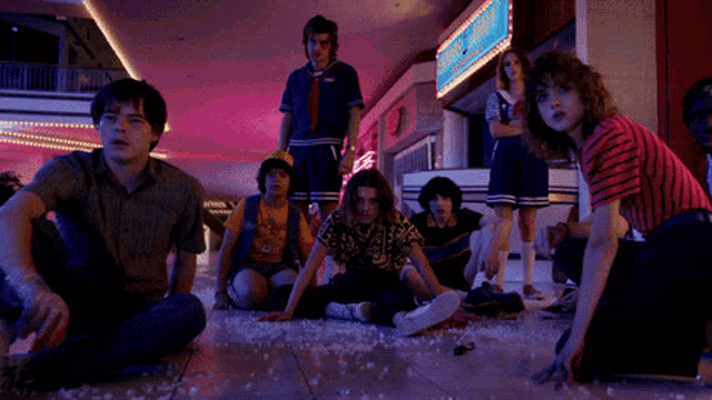 a group of people are sitting on the floor in front of a sign that says ' ice cream '
