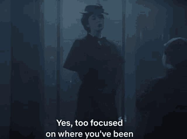 a man standing next to a woman with the words yes too focused on where you 've been below him