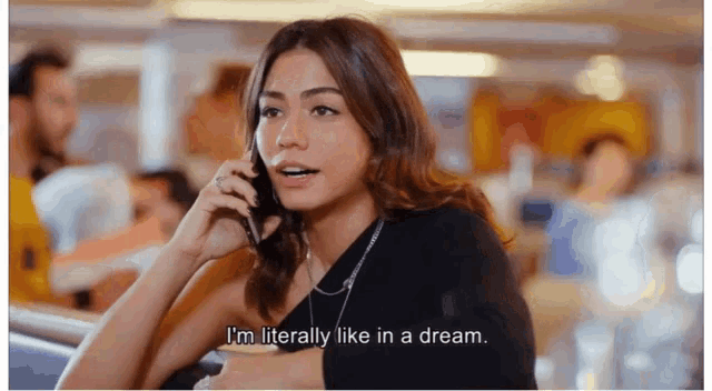 a woman talking on a cell phone with the words i 'm literally like in a dream below her