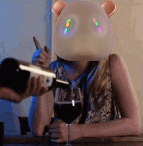 a woman sitting at a table with a glass of wine and a bear mask on her head