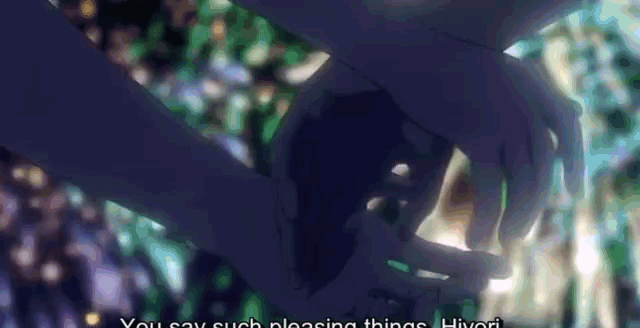 a close up of a person holding another person 's hand with a blurry background .