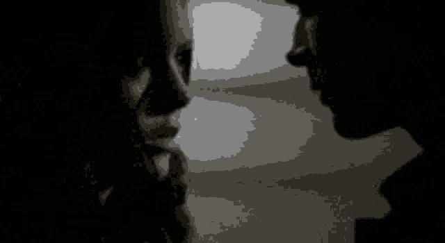 a man and a woman are looking into each other 's eyes .
