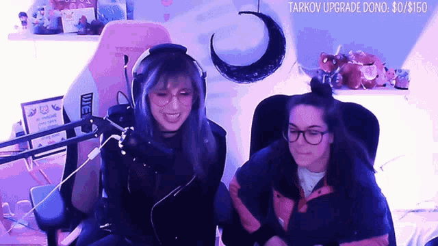 two women are sitting in front of a microphone with the words tarkov upgrade done on the bottom right