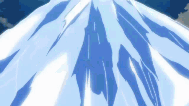 a mountain covered in snow and ice with a blue sky in the background