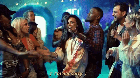 a group of people are dancing at a party and one of them is saying i 'm not sorry