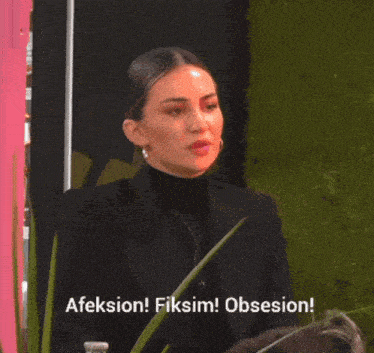 a woman in a black suit says " afeksion fiksim obsesion "