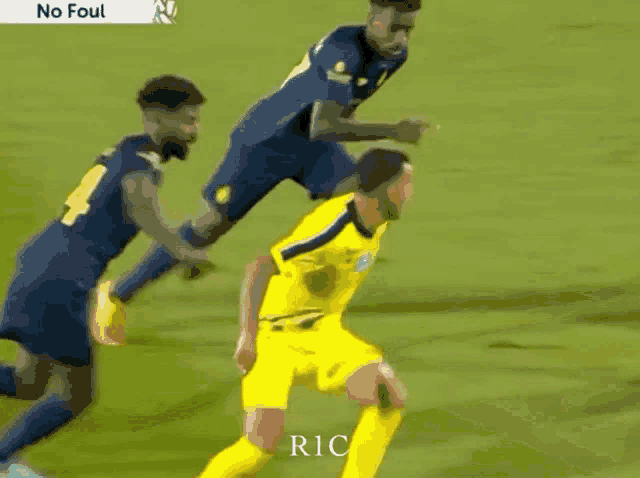 a soccer player in a yellow jersey with the word ric on the bottom right