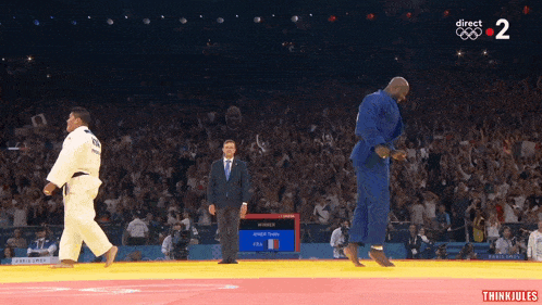 a judo match is being shown on a screen with the number 2 on it