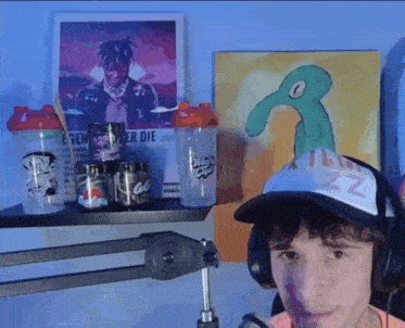 a young man wearing headphones and a hat with the letter z on it