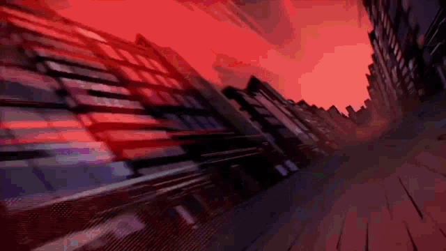 a cartoon drawing of a city street with a red sky in the background