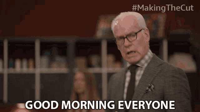 a man in a suit and tie is saying " good morning everyone "