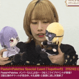 a girl is holding a stuffed doll with a mask on