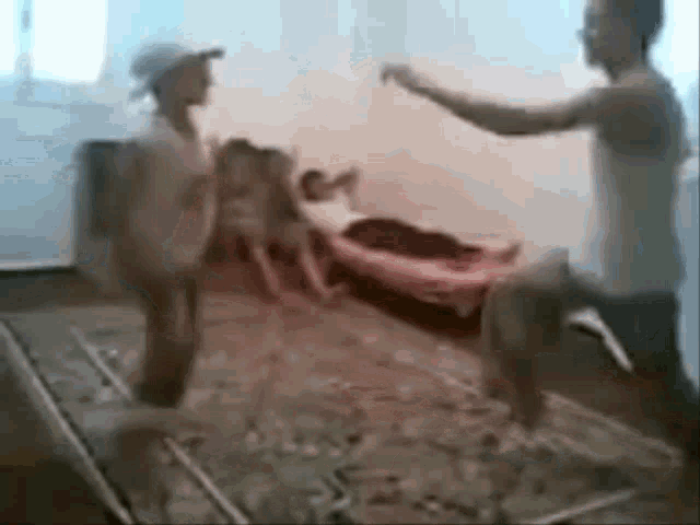 a group of people are dancing in a room with a man standing in the middle of the room holding a drum .