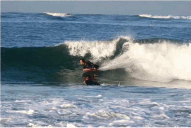 a person riding a wave in the ocean with a surfboard