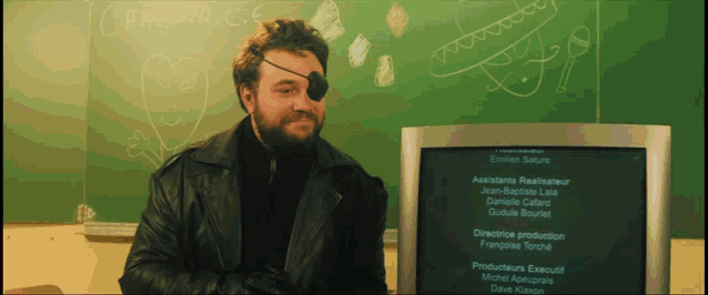 a man stands in front of a blackboard that says carapa.c.e