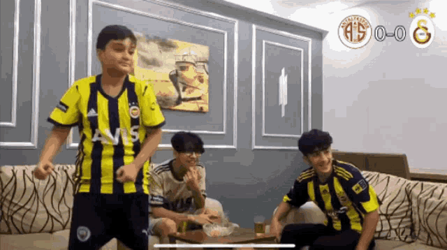 a boy in a yellow and black striped shirt with avis on the front