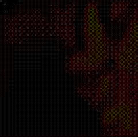 a close up of a person 's face with a glowing head in the dark .