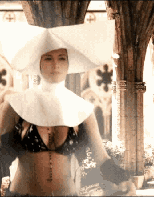 a woman in a bikini is dressed as a nun in a church